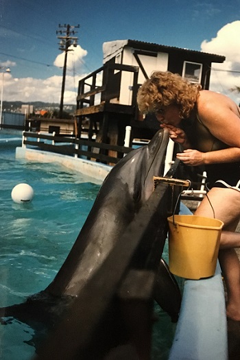 Sandy with a dolphin