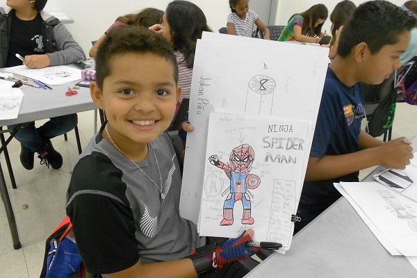 Boy holding his drawing