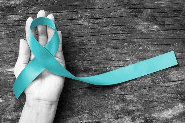 teal ribbon and a hand
