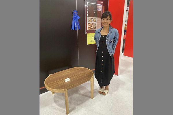 Woodworking student Shirley H with her award-winning table