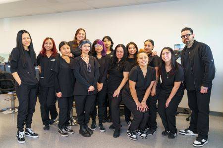 Cosmetology group with twelve students and instructor