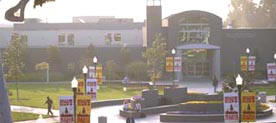 Cerritos College Falcon Square. The Falcon Square fountain and decorated light posts are in the foreground while the east face of the Library and Learning Resource Center building is show in the background.