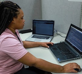 Female individual working at a computer station