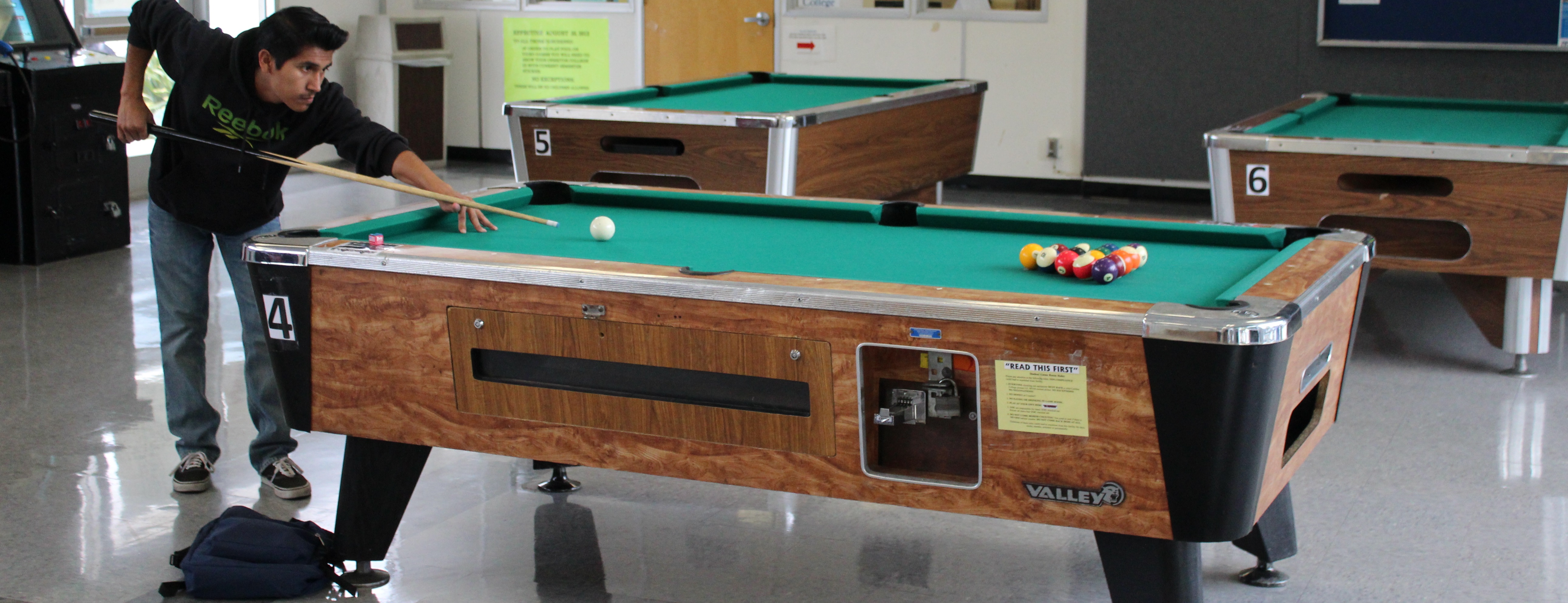 Student playing pool at the game room