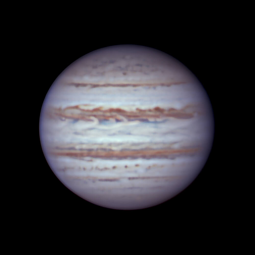 Jupiter with many multicolored horizontal belts and zones
