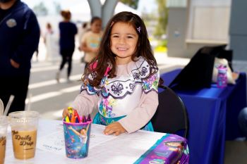 Little girl in Encanto costume coloring