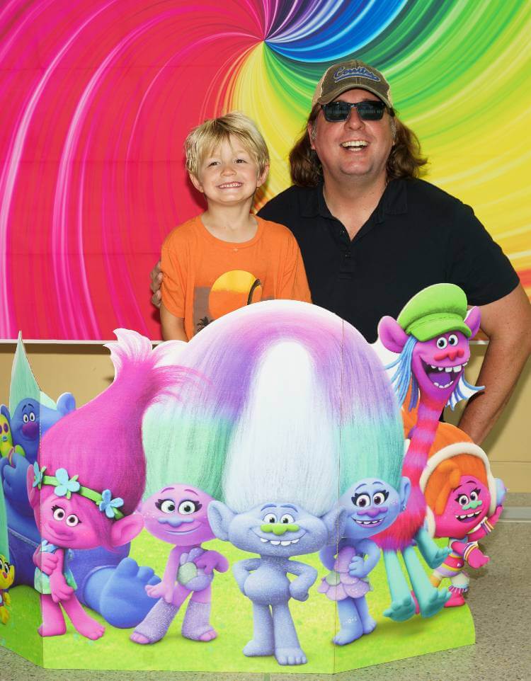 Father and Son behind Trolls Poster