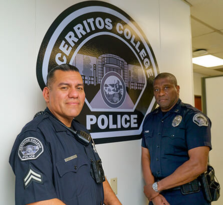 Police Officer smiling from inside of a patrol vehicle
