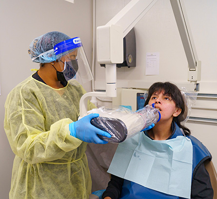Dental Assisting students learning from instructor Lydia Cosio