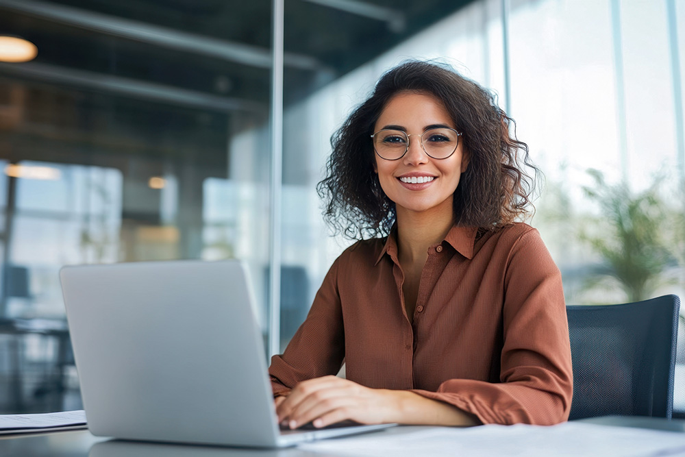 woman smiling at a computer