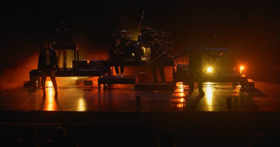 people of stage with dark lighting