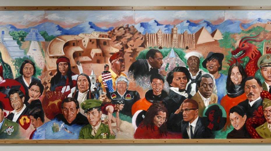 A wide, panoramic mural painting featuring a dense collage of prominent historical figures, civil rights leaders, and military service members from diverse racial and ethnic backgrounds. The background transitions across global landmarks and historical structures under a mountain range and blue sky.