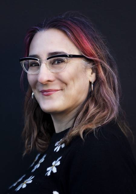 Woman with red hair and glasses