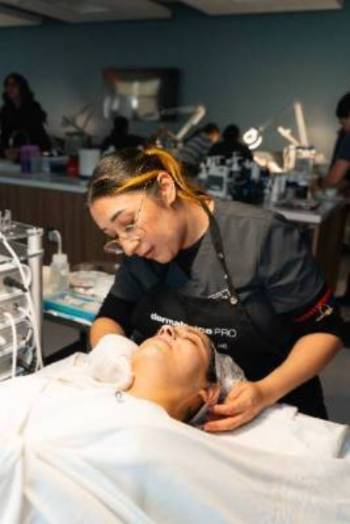Student performing a facial on a client