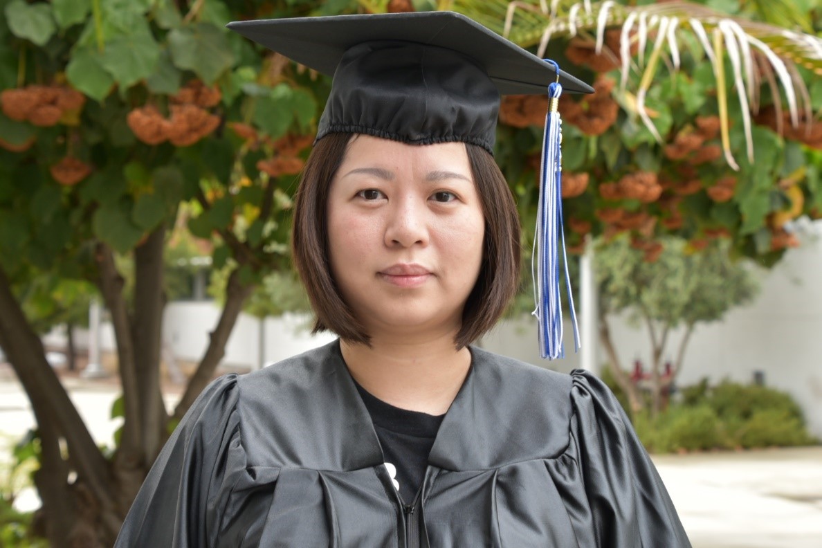 International students wearing cap and gown