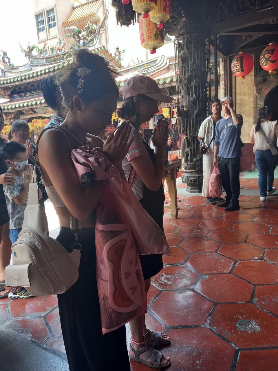 Student in prayer at temple