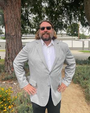 Chad Greene standing with suit