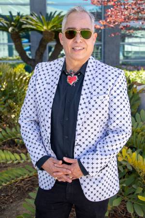 Forylan Cabuto posing with white polka dot suit jacket and sunglasses