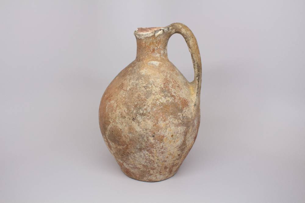 Jug with long spout and one handle.