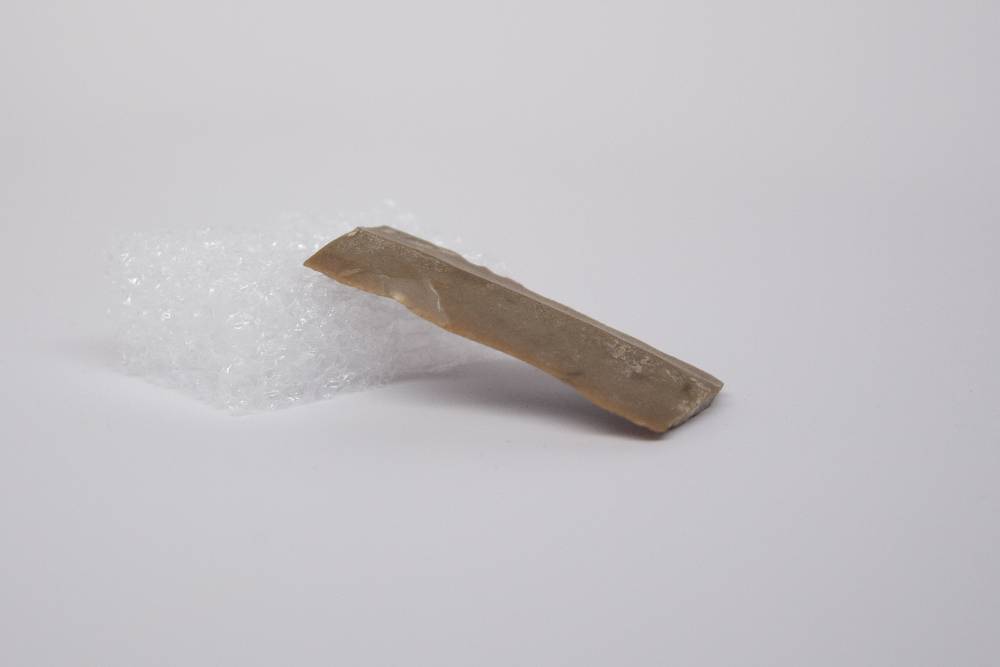 Semi-flat desaturated brown tool with beveled edges.