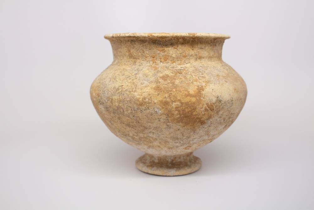 Large vase with small foot short neck and curved lip.