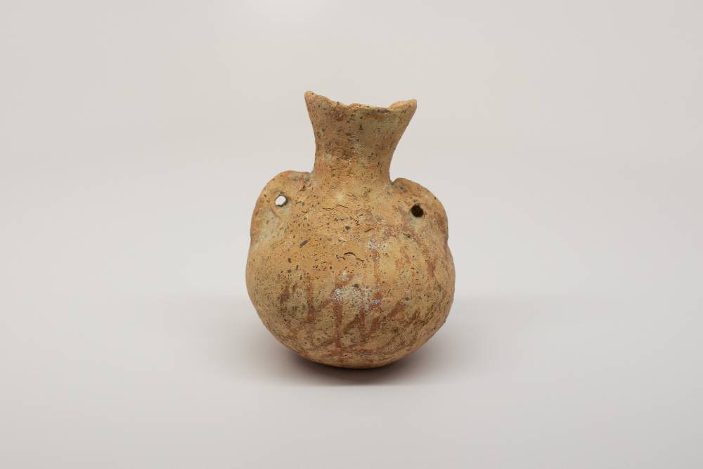 Amphora with two holes on the sides and a linear diamond pattern.
