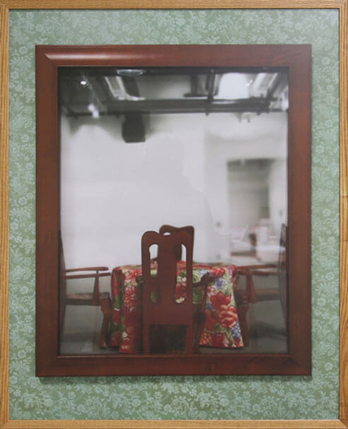 Framed dinging table inside another frame.