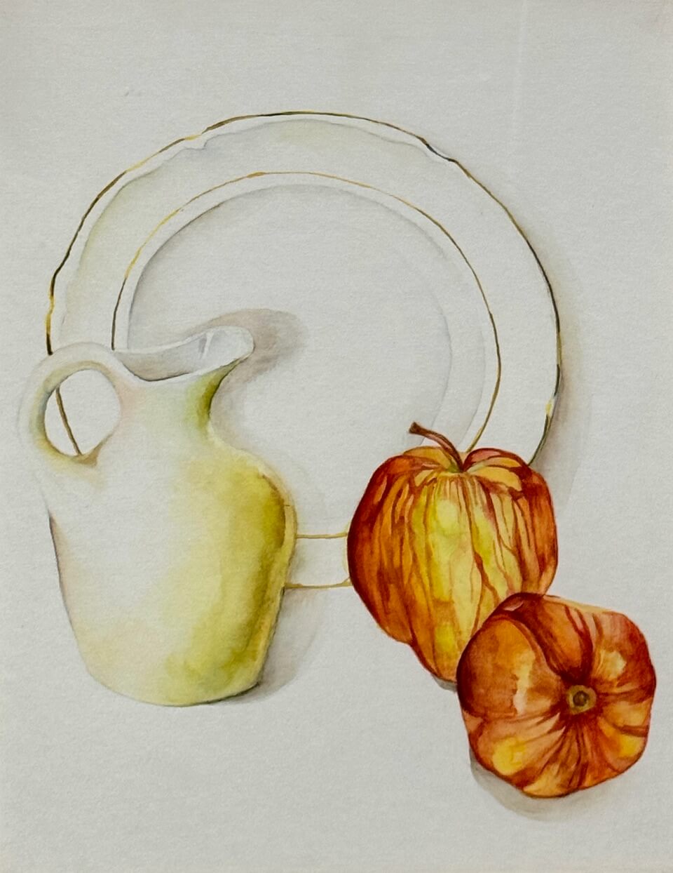 Plate in center with pitcher to the left and two red apples to the right.