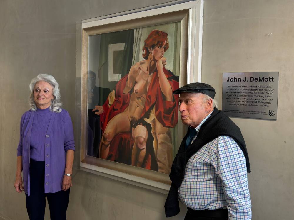 Margaret DeMott-Feldman and Louis Feldman next to figure study painting.