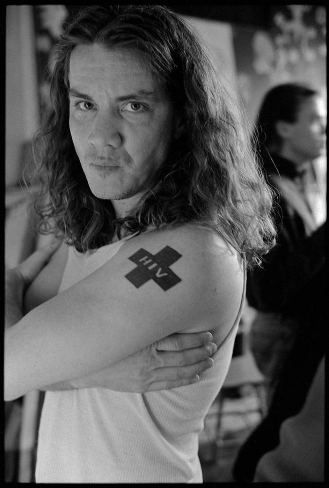 Bill Cullum with Red Cross that says HIV on arm.