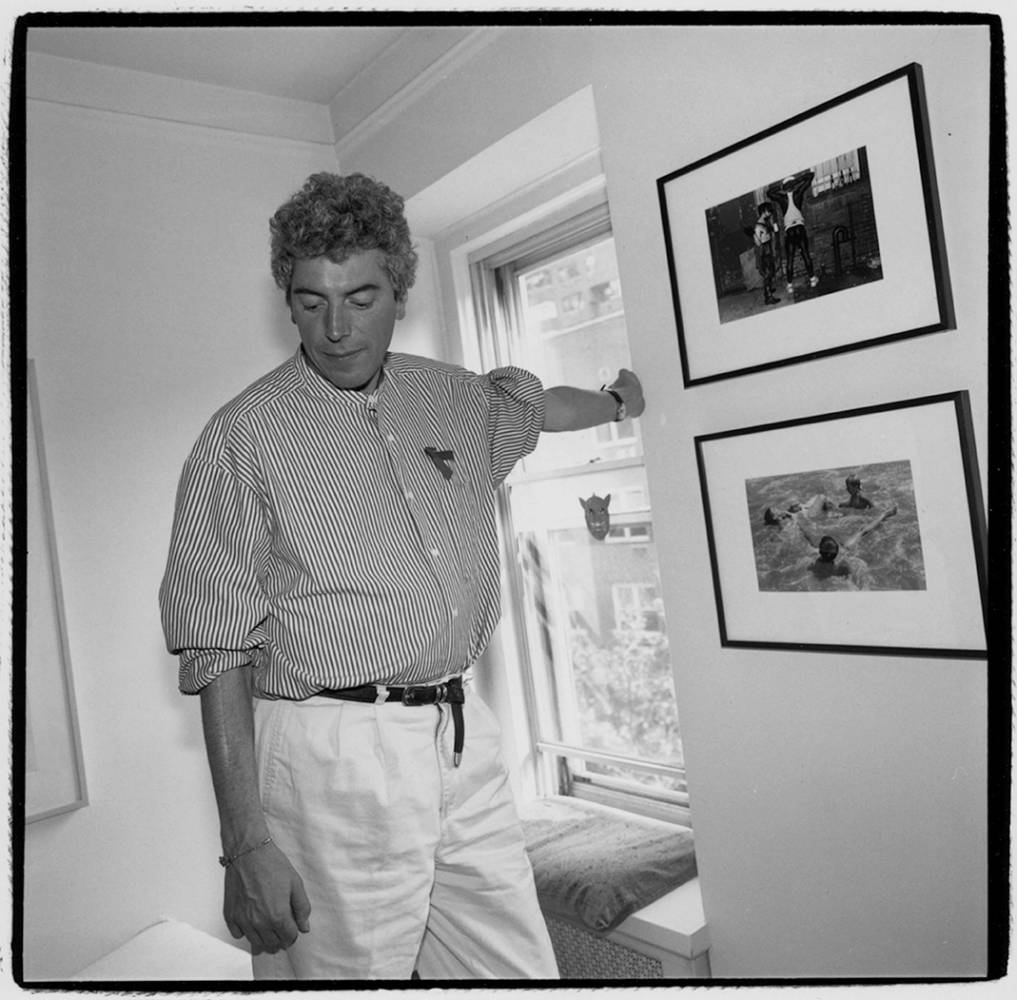 Patrick O'Connell leaning against wall next to window.