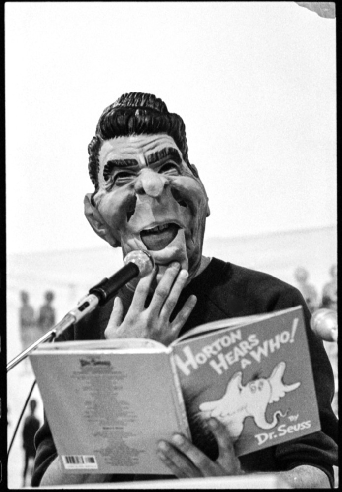 David Wojnarowicz wearing Reagan mask reading Horton Hears a Who.