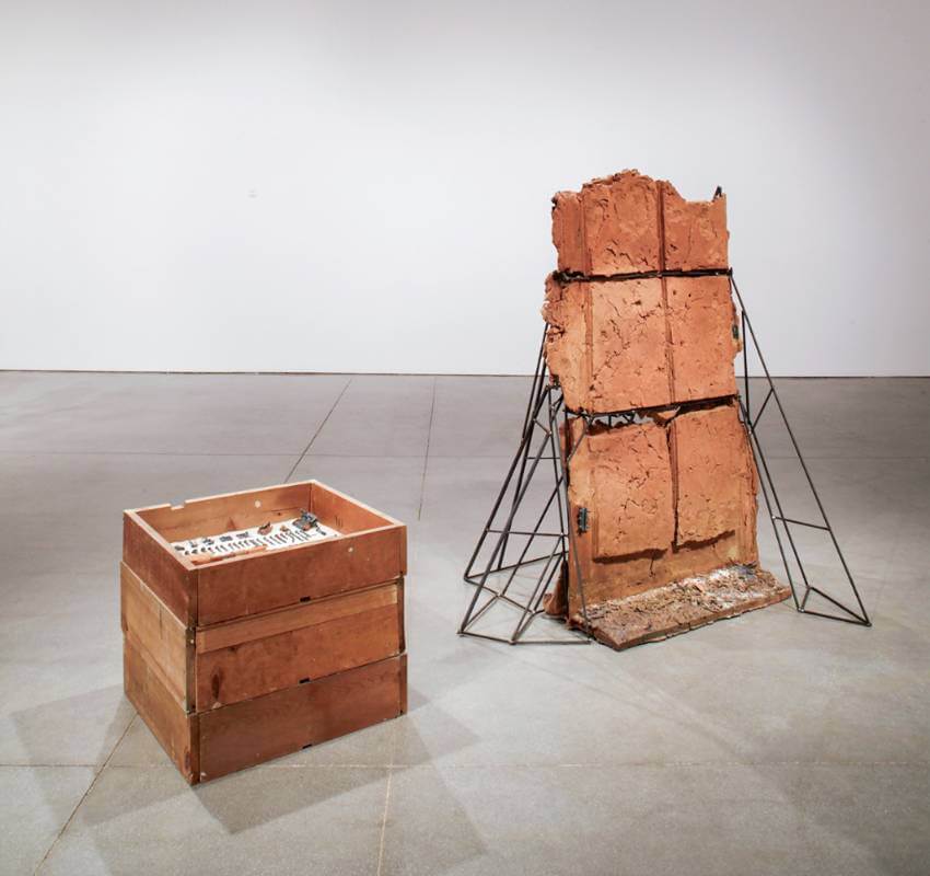 Wooden box next to rectangular ceramic on metal stand.