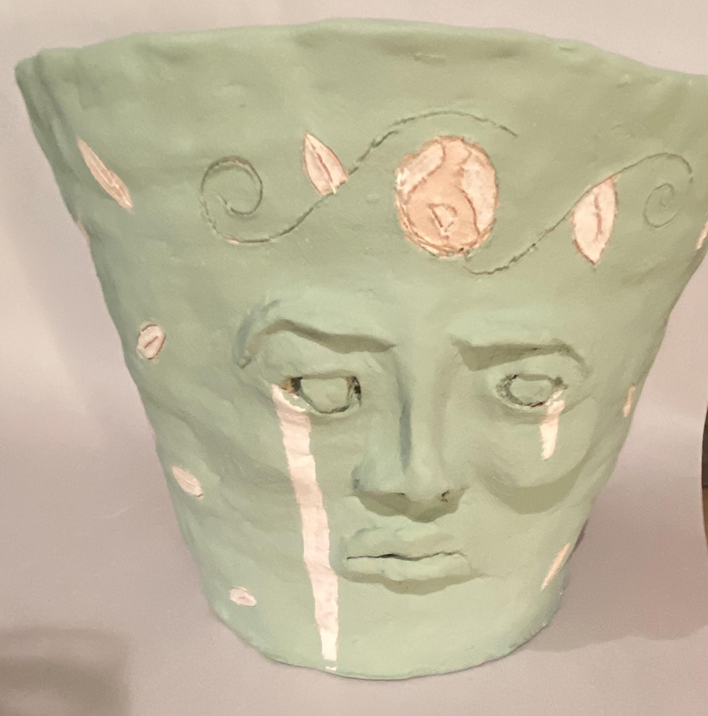 A Ceramic Vase with a Crying Face