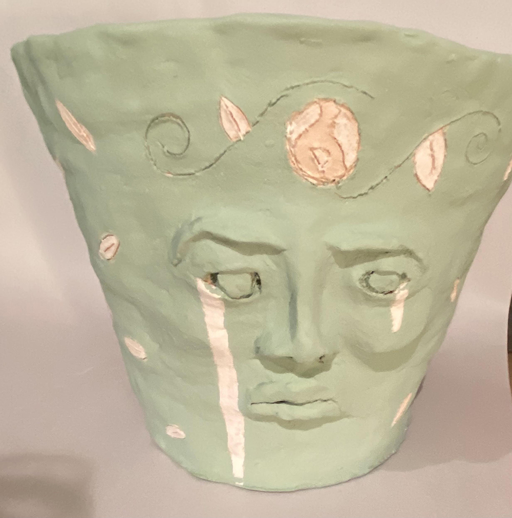 A Ceramic Vase with a Crying Face