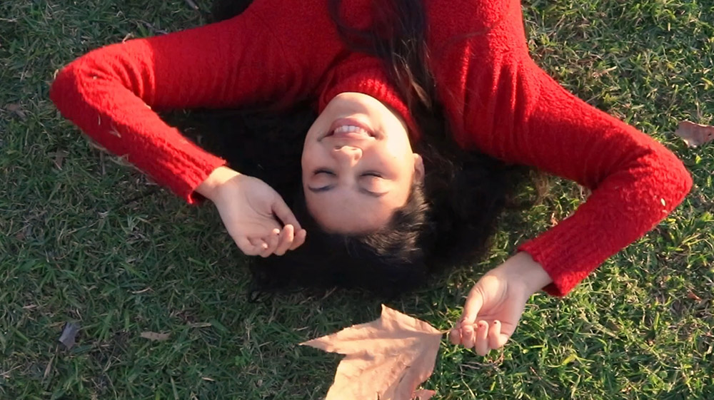 A woman laying in the grass