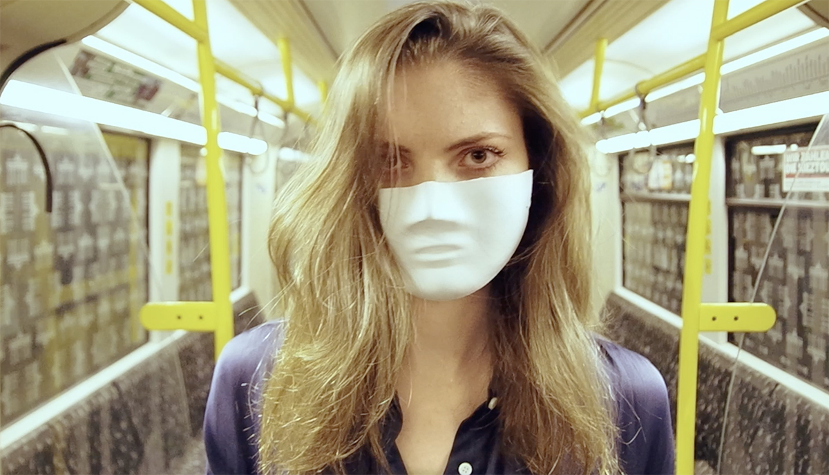 Video Still of woman wearing white mask on a bus