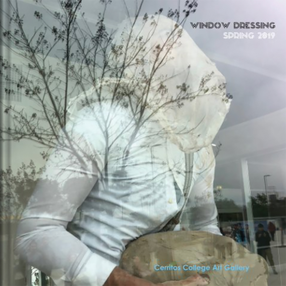 Man in Mask Holding Clay Behind Reflective Window