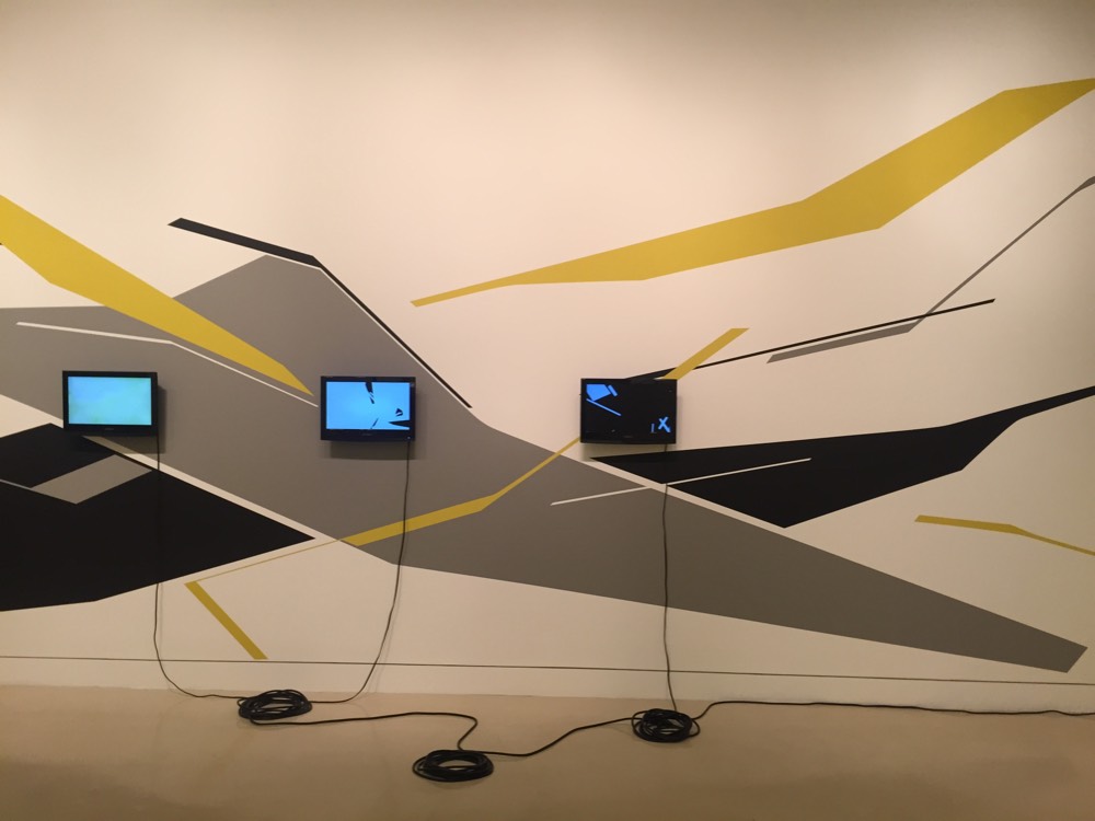 Tv's mounted of painted wall.