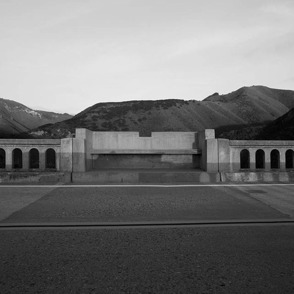 Bridge with hills in the background in black and white.