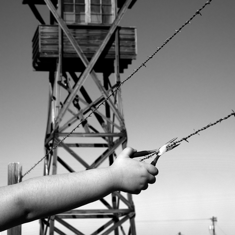 A hand clipping barbed wire