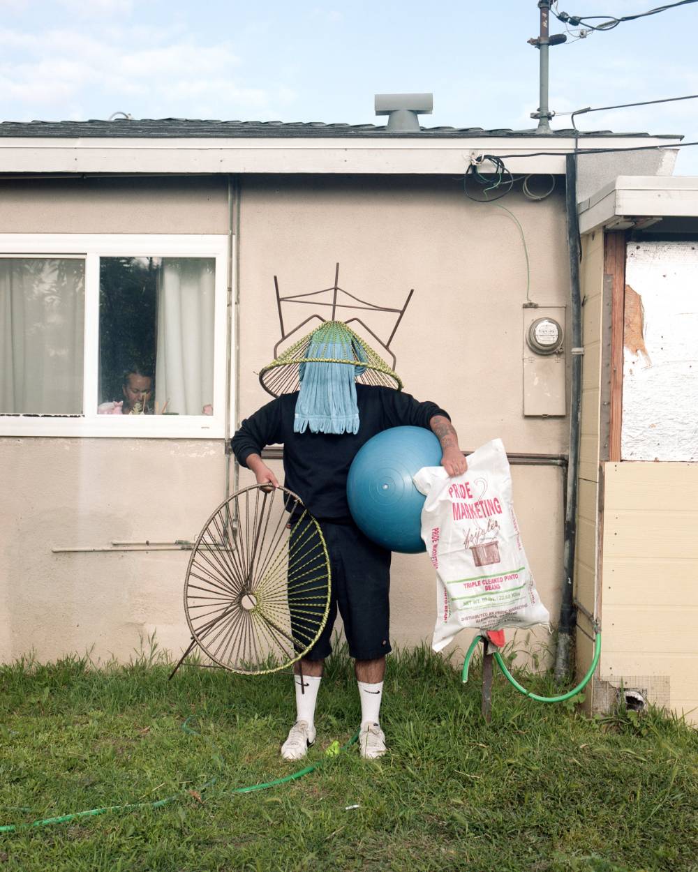 William Camargo, All That I Can Carry #2, Inkjet Print, 2020 Person With Chair on Head Holding Ball