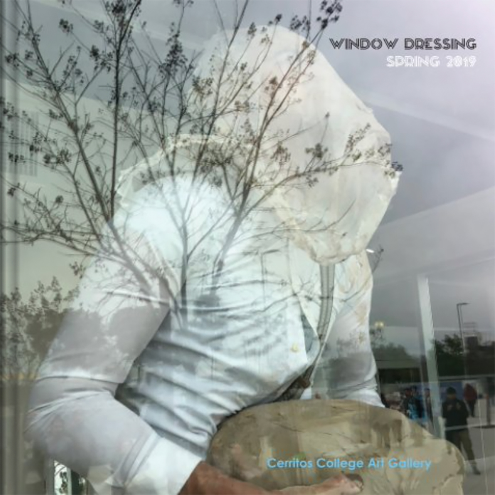 Man in Mask Holding Clay Behind Reflective Window Man in Mask Holding Clay Behind Reflective Window