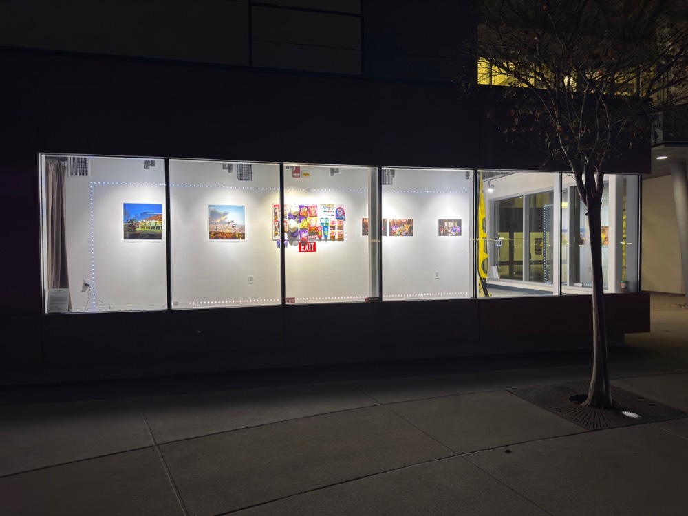 illuminated window with artwork from bodegones and street lights