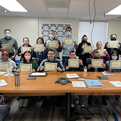 Excel training group holding certificates of completion