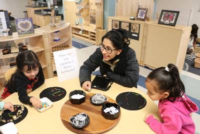 Nancy Anaya working with two girls