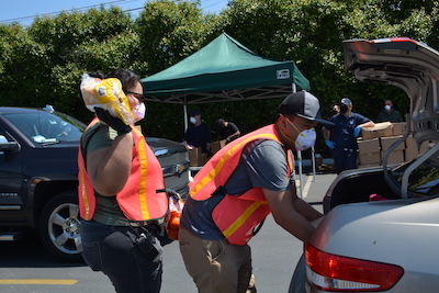 Volunteers loading items in a car