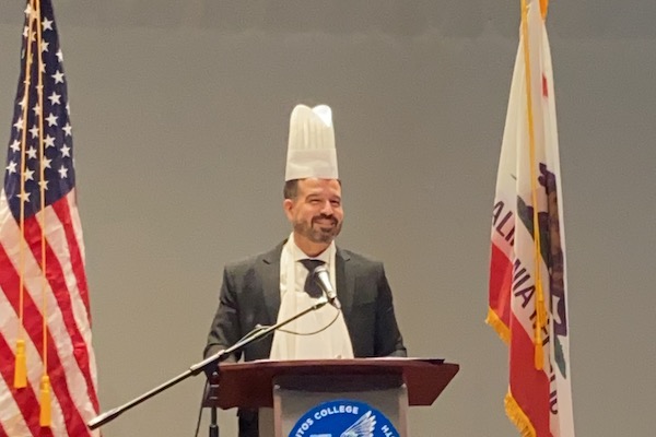 Dr. Jose Fierro in chefs hat and apron