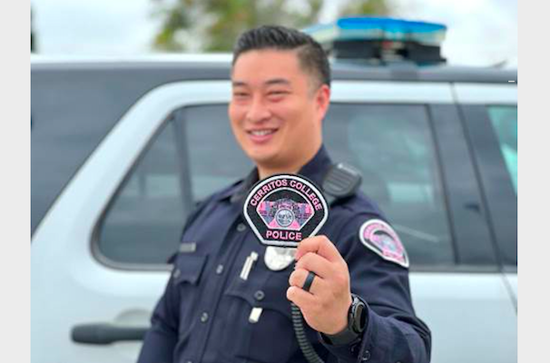 Campus police officer holding a pink patch
