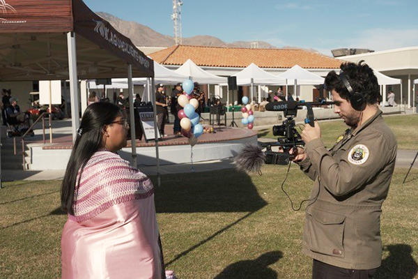 Roberto Hoyos filming a woman